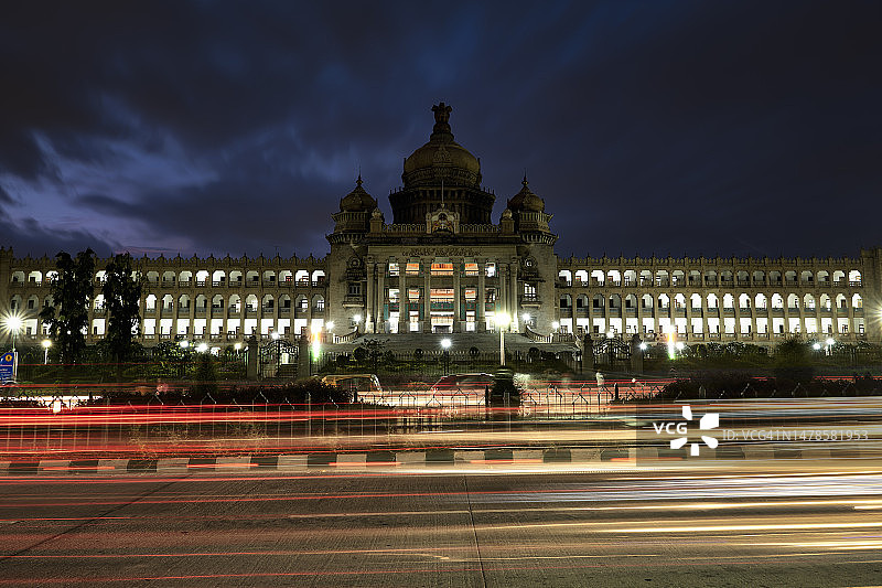 傍晚时分，印度卡纳塔克邦班加罗尔的立法大楼的交通灯光轨迹图片素材