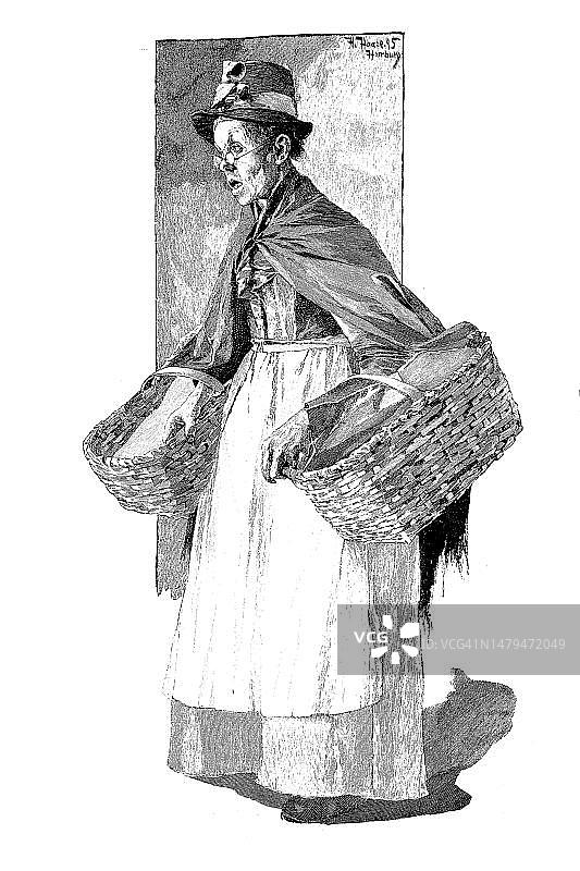 1880年德国基尔的鱼贩与两个篮子（历史照片，19世纪原版数字修复复制品，确切的原始日期未知）图片素材