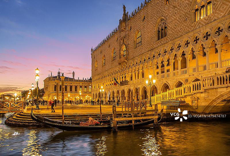 威尼斯总督宫：日落后黄昏时分海滨的贡多拉，意大利威尼托图片素材