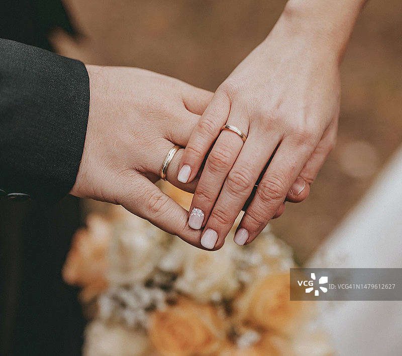 戴着戒指的婚礼夫妇的手图片素材