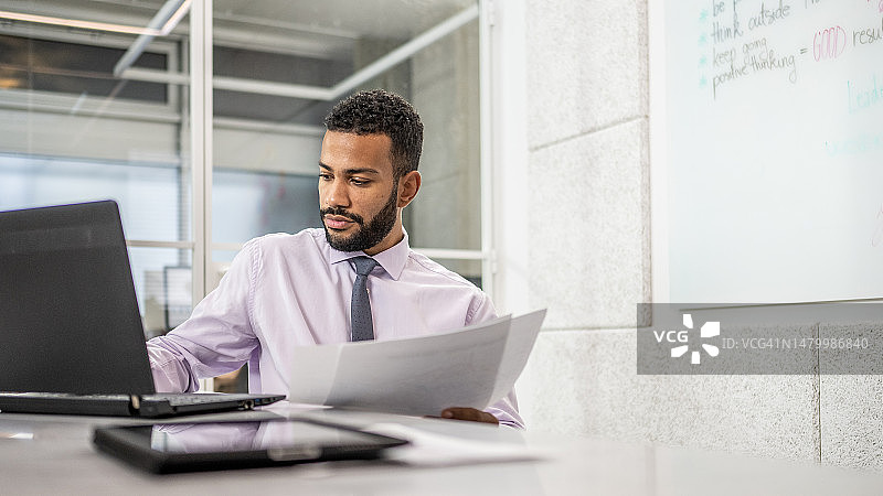在办公室使用笔记本电脑的商人图片素材