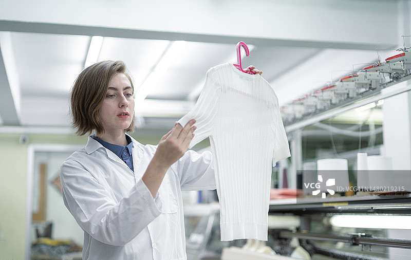 年轻女性在工厂检查时尚工作图片素材