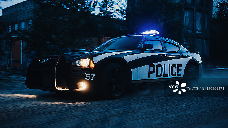 在工业区追捕的交通巡逻车。警官驾驶警车，在工业道路上追捕嫌疑人，警笛，高速。警察紧急反应。电影动作图片素材
