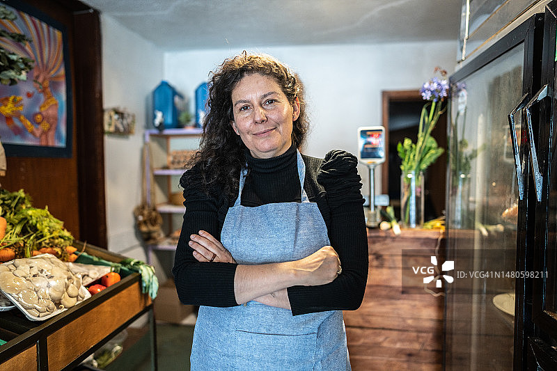 在当地小商店的中年女售货员肖像图片素材