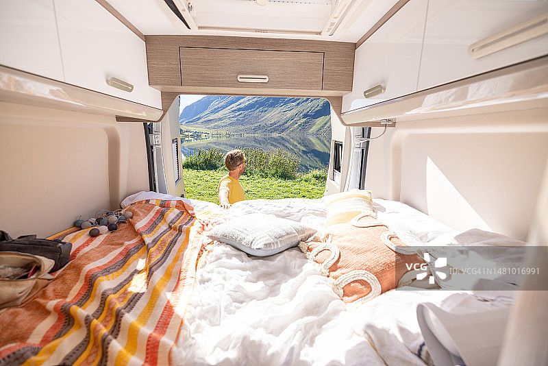 男子在露营车后放松身心，享受露营生活图片素材