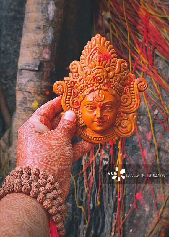 手持印度教女神杜尔迦神像的女人图片素材