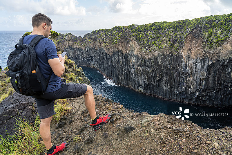 男人在火山悬崖边，特塞拉岛，亚速尔群岛图片素材