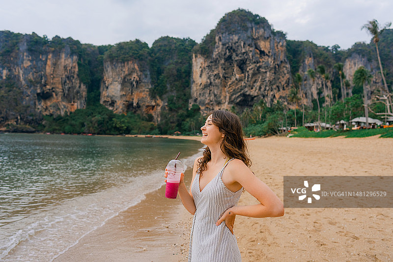 在海滩上喝冰沙的女人图片素材