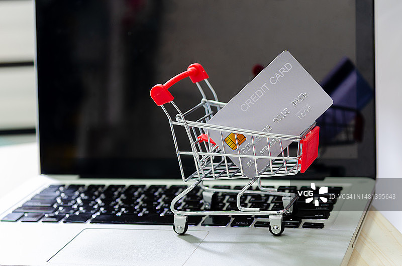电脑笔记本上的购物车中的信用卡图片素材