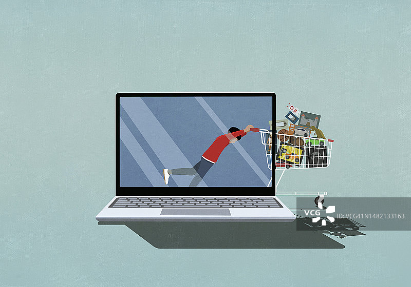男孩在网上购物，在笔记本电脑屏幕上推动装满玩具的购物车图片素材