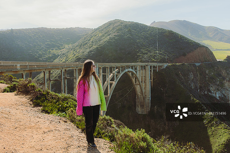 女旅行者在加利福尼亚州探索风景秀丽的比克斯比河大桥图片素材