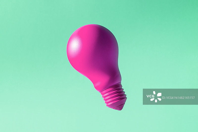 绿色背景上的紫色白炽灯泡图片素材