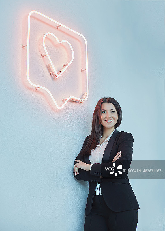 在带有感谢标志的白墙前摆姿势的女商人图片素材