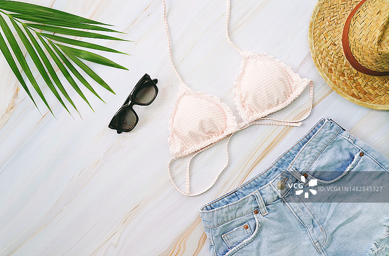 比基尼、太阳镜、牛仔裤、帽子和热带植物的夏季物品扁平风格照片图片素材