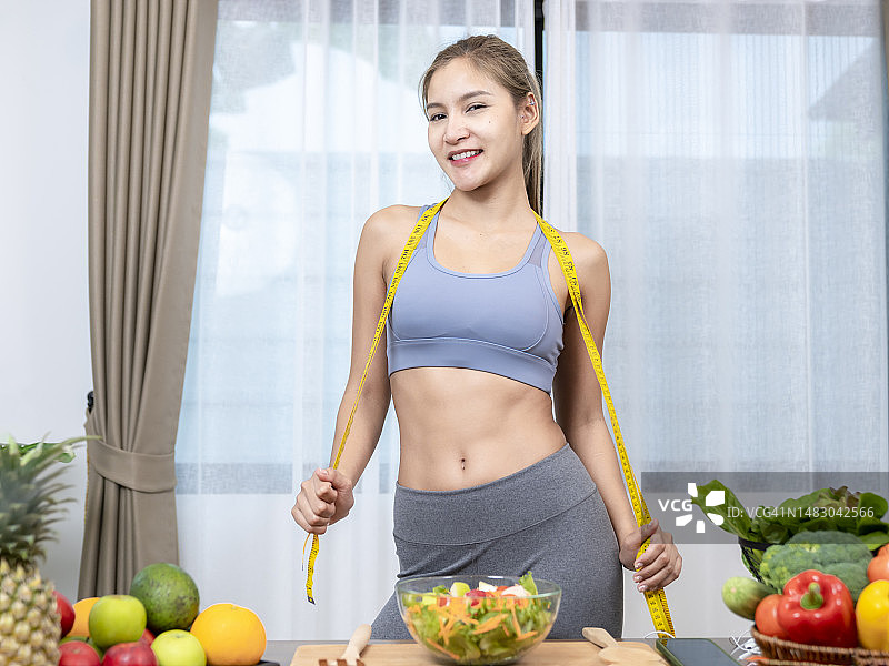 身材健康的女子在家中展示蔬菜图片素材