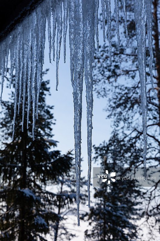 冬季芬兰卡亚尼附近奥卢湖冰封湖面上的小屋巨型冰柱图片素材