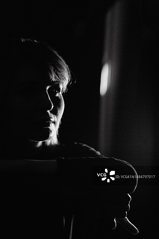 黑色背景下手持葡萄酒杯的漂亮女人单色剪影图片素材