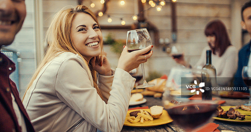 一群年轻人在公寓的露台上享用日落午餐图片素材