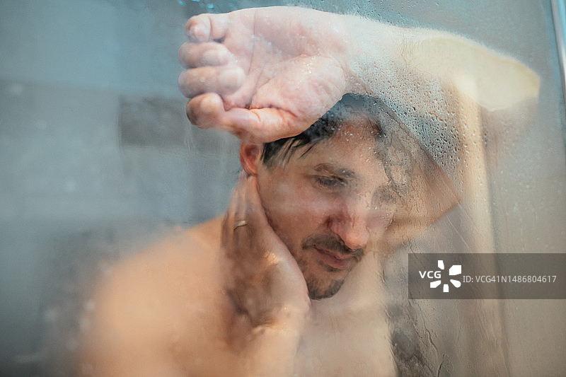 疲惫悲伤的男人在淋浴图片素材