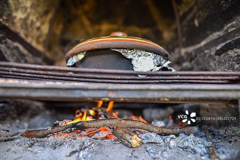 传统欧洲肉类烹饪：在石炉中用陶罐在火上烹饪图片素材