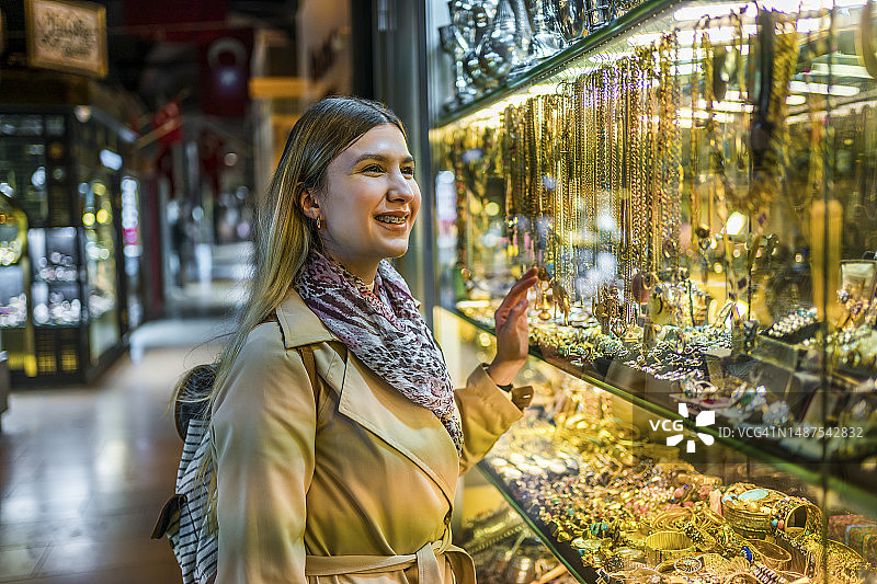 看着珠宝店橱窗的女人图片素材