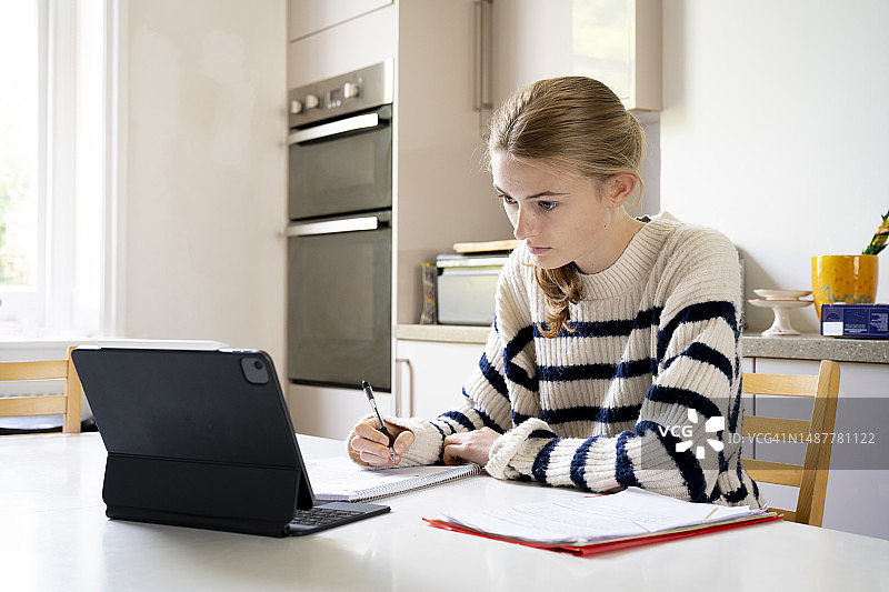 在家使用平板电脑学习的少女图片素材