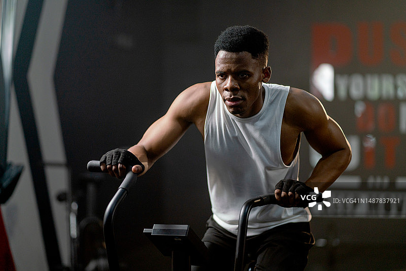 非裔美国运动员在健身房使用椭圆机锻炼图片素材
