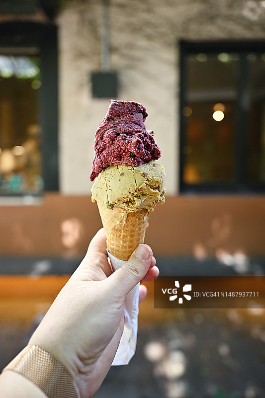 手持双色冰淇淋甜筒图片素材