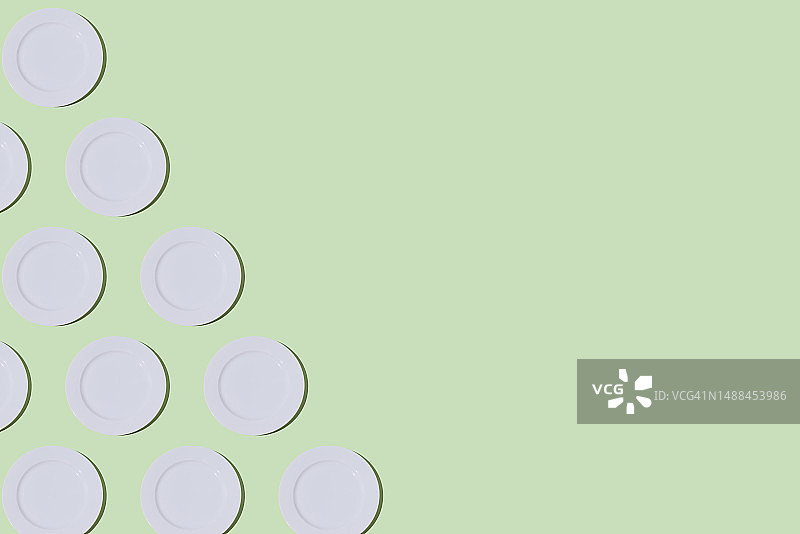 浅绿色背景上的空白餐盘图案：餐饮、烹饪和美食概念图片素材