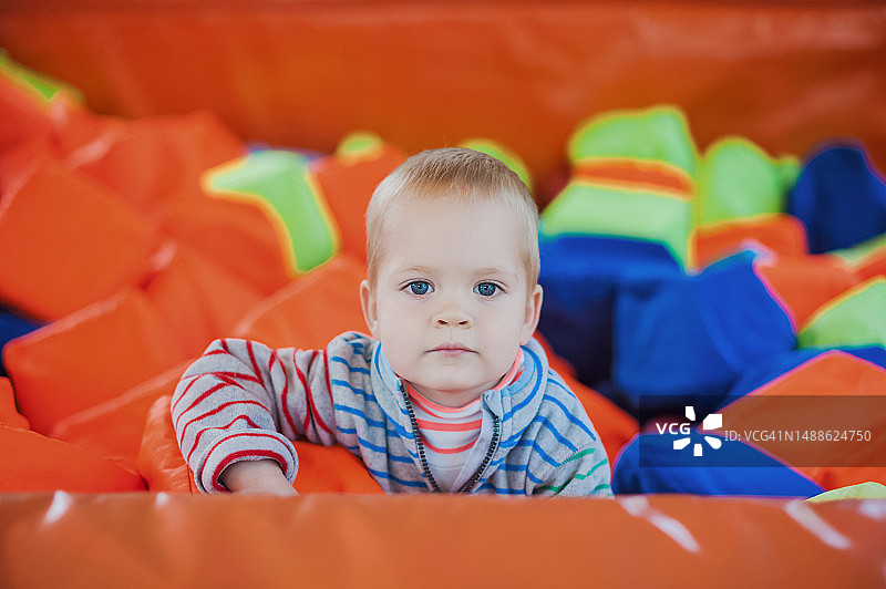 幼儿男孩在蹦床上进行户外活动图片素材