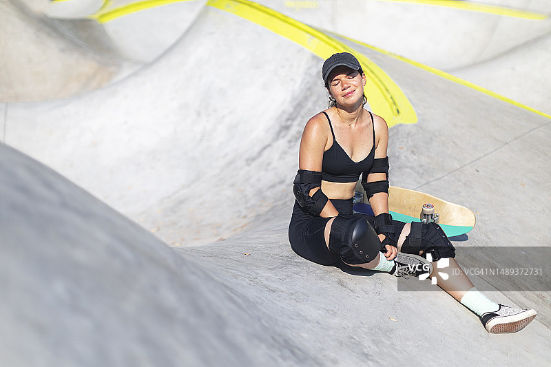 在滑板公园休息的年轻女子图片素材