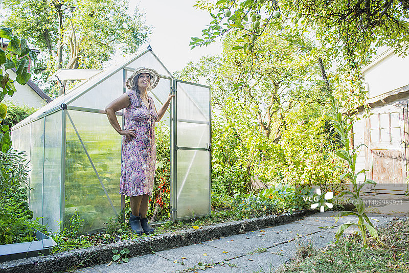 德国巴伐利亚州阿尔特廷，花园温室中的老年女性图片素材