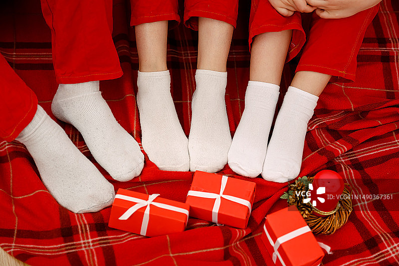 冬季，圣诞树旁穿着羊毛袜的双脚图片素材