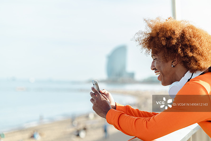 年轻男人在户外使用手机的侧面照图片素材
