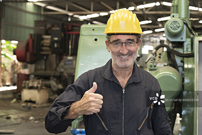 工厂里的年长机械技师肖像图片素材