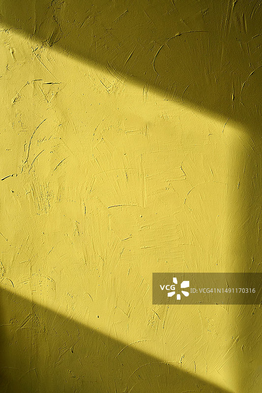 抽象背景。黄色纹理石膏墙。图片素材