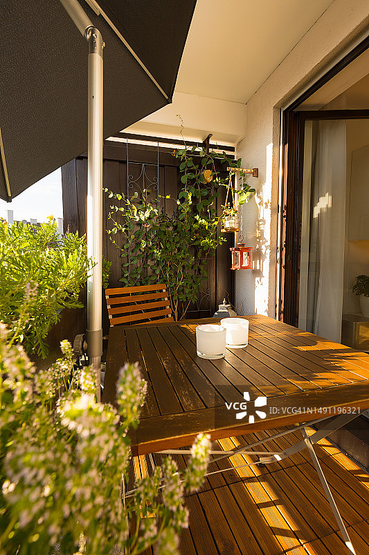 德国带有绿色植物、家具和遮阳篷的小阳台图片素材