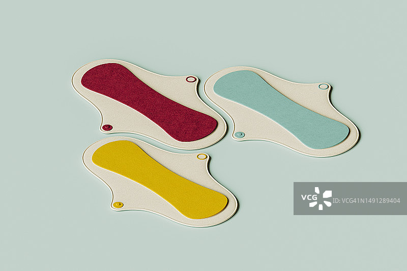 黄色、红色和绿色卫生巾平放在绿色背景上的3D渲染图片素材