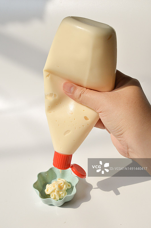 从挤压瓶中倒蛋黄酱图片素材