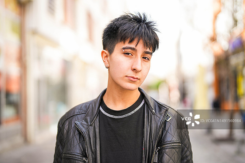 身穿皮夹克、面部穿孔的年轻短发女子的肖像图片素材