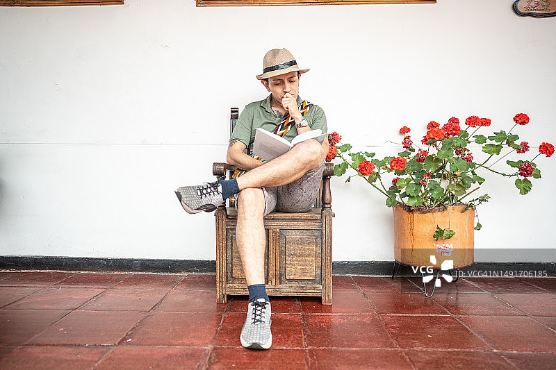 年轻旅行者在旅馆看书图片素材