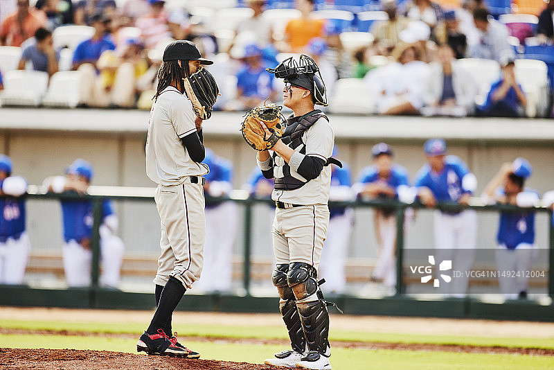 棒球比赛中投手和捕手讨论广角镜头图片素材