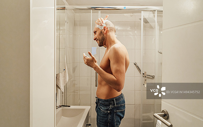 男人在镜子前涂剃须膏图片素材