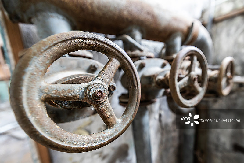 废弃建筑中的旧管道阀门图片素材