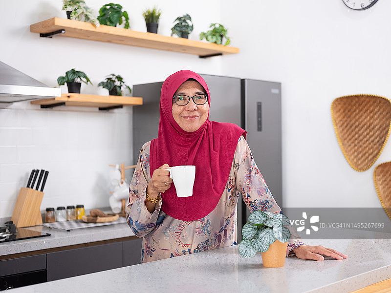 年长女性在现代厨房里图片素材