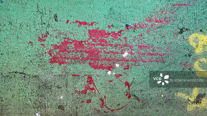 美国纽约曼哈顿街道绿色沥青上刮擦和着色的黄色和红色油漆痕迹图片素材