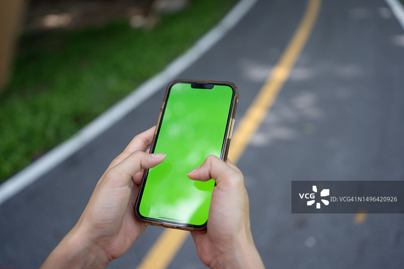 穿红色衬衫使用手机的运动女人图片素材