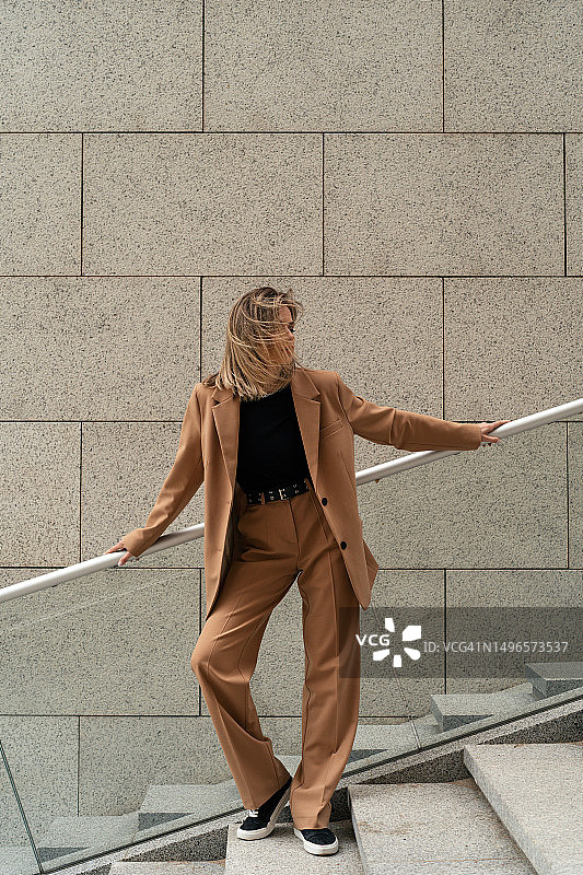 穿着裤装站在建筑物外台阶上的女商人肖像，白俄罗斯图片素材