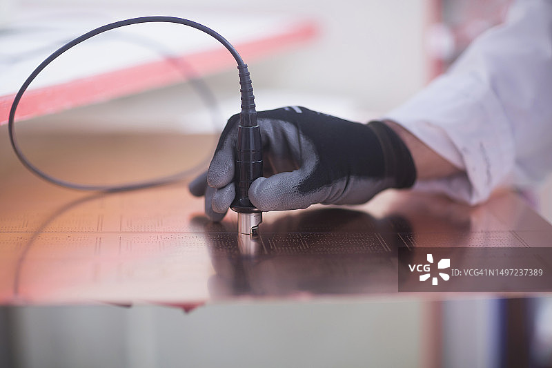 人手检查电路板特写，德国下萨克森州汉诺威图片素材