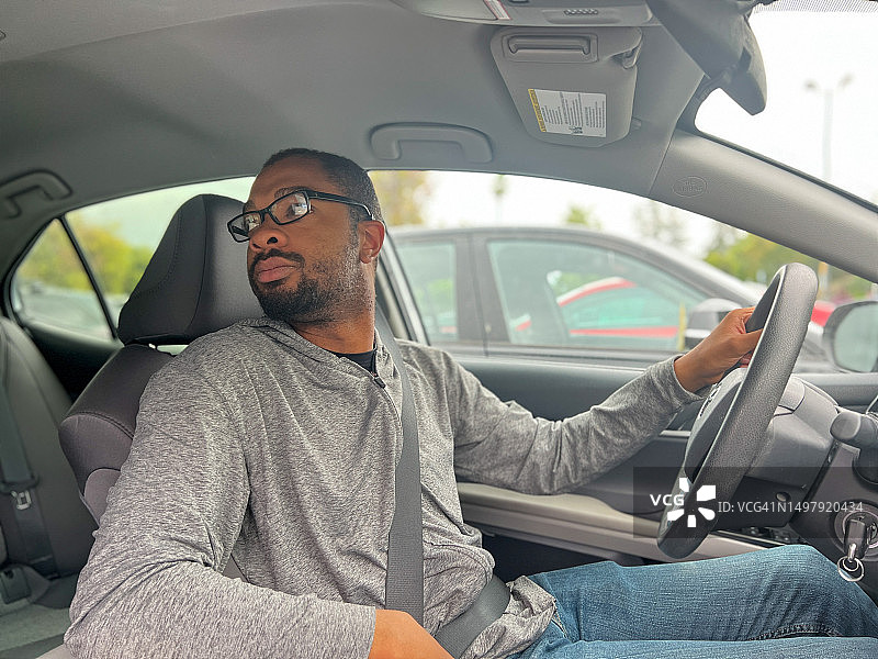 自闭症男子开车回头看的肖像图片素材